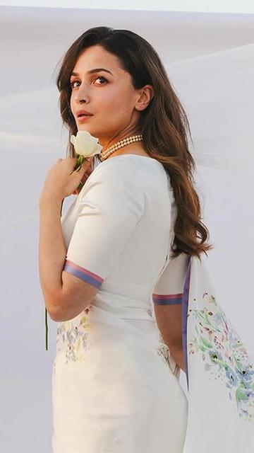 Alia Bhatt once again proved why she’s a fashion icon. At the Raj Kapoor event, she opted for a white floral saree designed by Sabyasachi. With its intricate floral patterns and elegant draping, the saree was a testament to Sabyasachi’s design brilliance. Alia’s minimalist styling elevated the look to perfection.