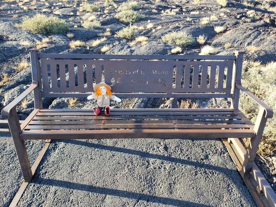 Ranger Sarah takes a break on a cool bench. Pahoehoe flows are often seen flowing like glowing orange rivers. As the surface of a pahoehoe flow cools it forms a sort of "skin."
— at Craters of the Moon NPS.
