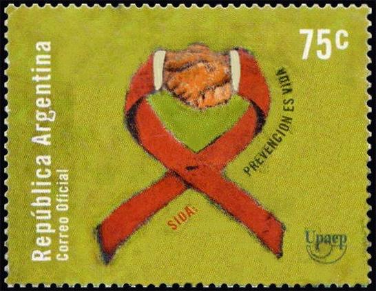 AIDS awareness postage stamp featuring a red ribbon, clasped hands, and Spanish text promoting prevention.