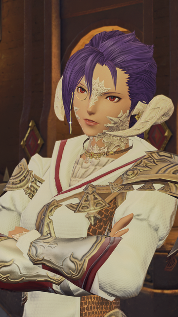 Closeup of Berin Rinrin talking with her arms crossed in front of her. She is wearing a monocle and golden accessories.