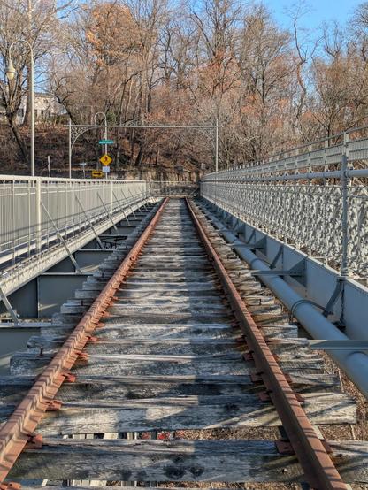 Photo of an old trolley track atop a late 19th century iron bridge.