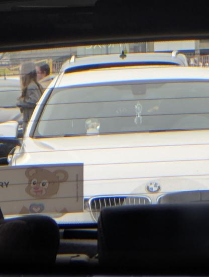 a white BMW with what looks like a glass snow globe on the dashboard.