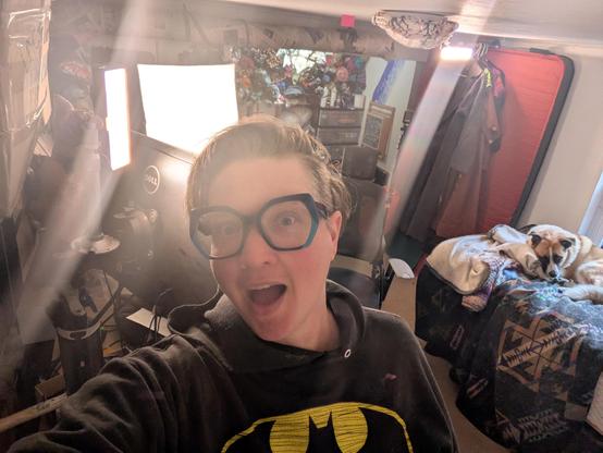 Me with a goofy face in my studio with 4 very bright lights and a dog