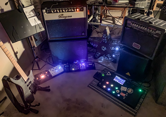 Guitar amps, pedals, and a guitar. 