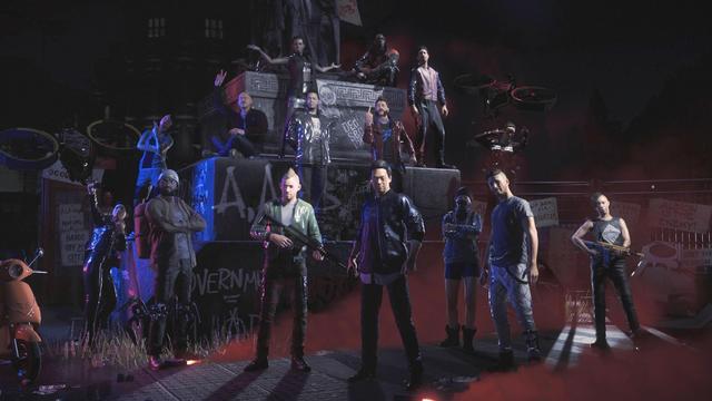 The image depicts a group of diverse characters standing in a dramatic, urban setting, likely inspired by a dystopian or futuristic theme. They are positioned in front of a large statue or monument, which is partially obscured by graffiti and posters. The atmosphere is dark and moody, enhanced by red and blue lighting that creates a sense of tension.