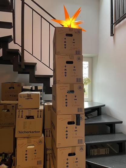 A stairway with in the front boxes with on top a yellow star.