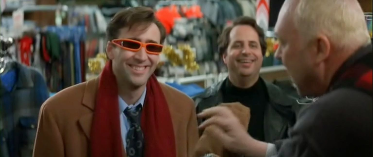 Nicolas Cage (left) wearing strange sunglasses and Jon Lovitz (right) while shopping during Trapped in Paradise, a 1994 holiday crime comedy movie.