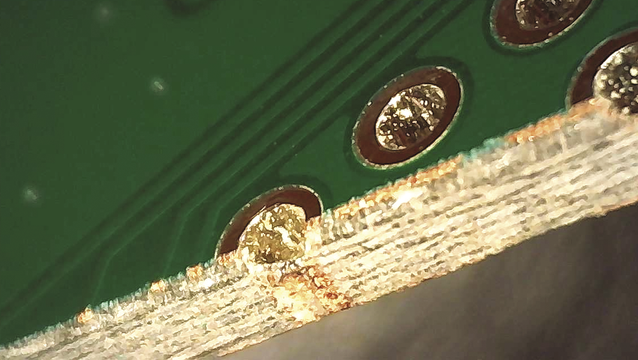 Image of a cross section of a PCB showing vias (copper color), tracks covered in resist (green), non-copper area (darker green), the substrate (yellow/gold), the GIT repos are now in place.