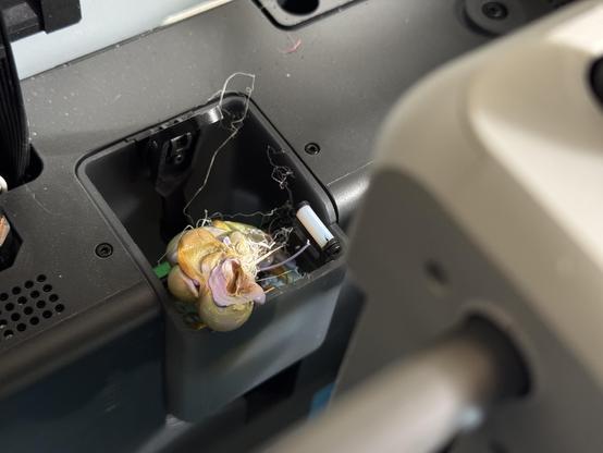 A blob of melted PLA at the poop chute of my BambuLab X1C printer.