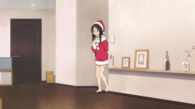 A girl (Mia) with a nervous expression on her face wearing a red and white Santa dress with a hat.