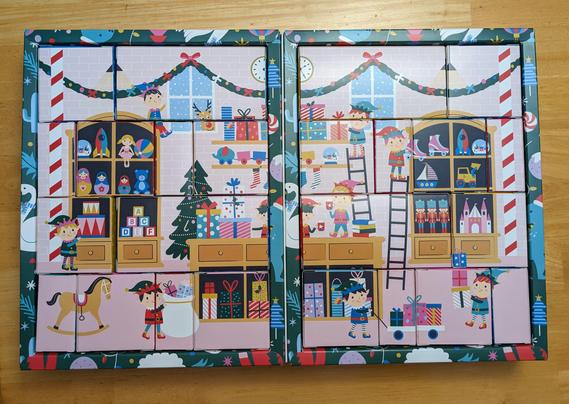 An advent calendar with all the boxes flipped backwards showing a festive Christmas toyshop scene with elves stocking all the shelves.