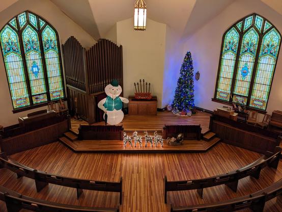 Holiday decorations (and a six-necked guitar) on the altar area of the church building I own. 