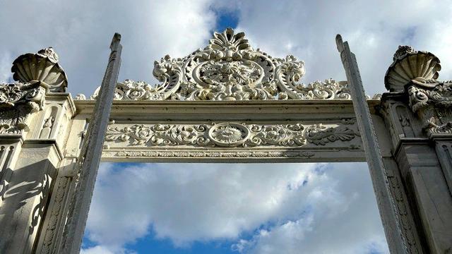 Carved stone gateway with blue sky in background.