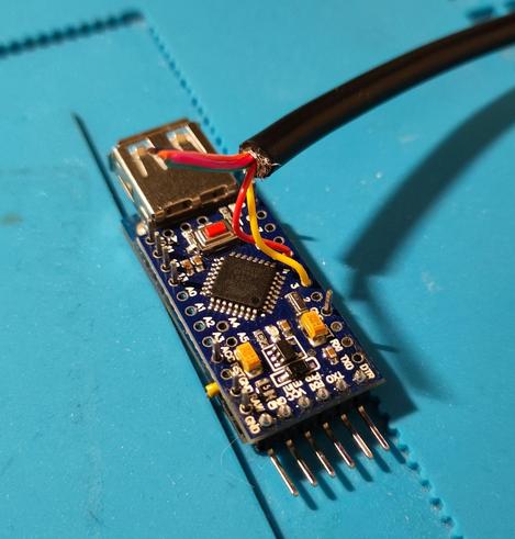 Closeup shot of the adapter, work-in-progress. Some wires are already soldered in, but the USB shield is not soldered on yet.