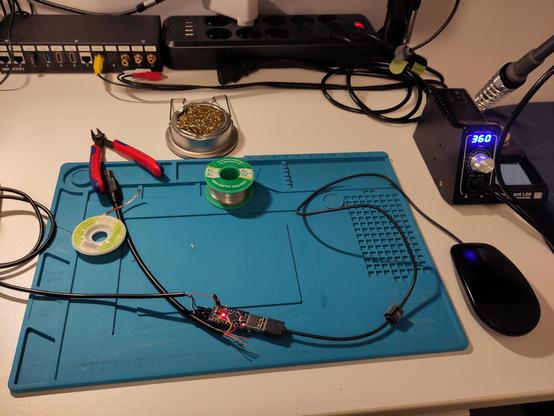 Big work-in-progress mess on the desktop. The Arduino programmer serial adapter is hooked up, the soldering iron is hot, and there are other various tools required for the work.