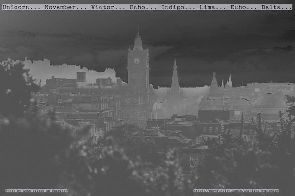Edinburgh Skyline from Calton Hill, Photo by Adam Wilson on Unsplash and modified by More Fun With Games team, colour gradient changed to be almost negative, typewriter text in phonetic alphabet across top of skyline