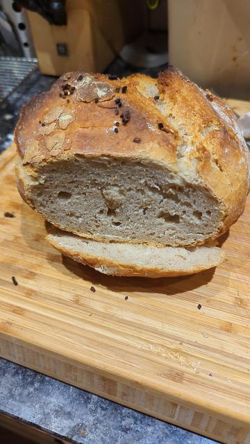 Round sourdough loaf with a slice cut off the end