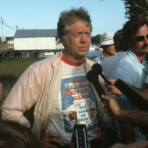 Presidential candidate Jimmy Carter talks to reporters while wearing an Allman Brothers Band T-shirt, July 1976. Wally McNamee/Getty Images