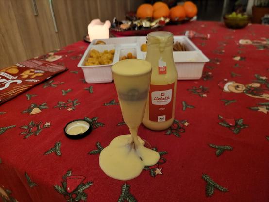 Glas mit Eierlikör was beim Eingießen übergelaufen ist. 