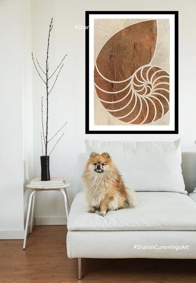 Rich milk chocolate colored nautilus shell in a decor setting with a Pomeranian dog by artist Sharon Cummings.