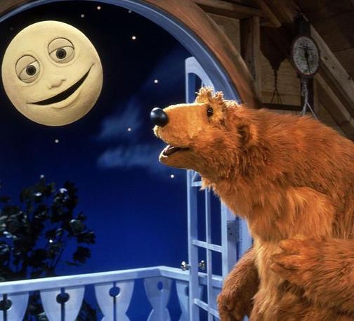 Bear from "Bear in the big blue house" smiling at the Moon.