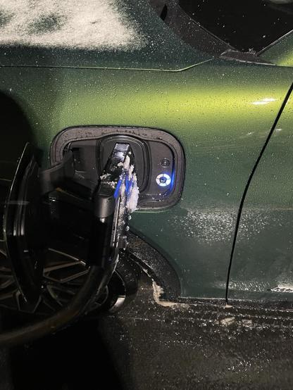Fast charging Mach-E as snow falls.