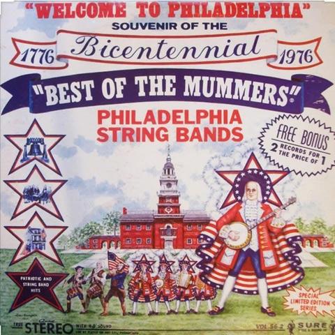 1976 "Best of the Mummers" string Band album cover featuring a bicentennial theme. Philadelphia's Independence Hall is seen in the background. A atring band in colonial costumes is seen in the front.