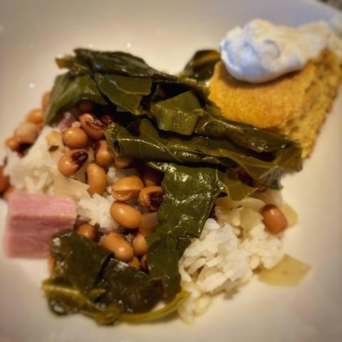 New Year’s Day Hoppin’ John (collard greens, black-eyed peas, and rice) with a little ham, cornbread, and sour cream.