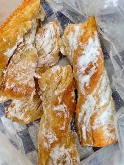 Some sweet pastry from Panadería «Chisclay» in Loarre, Huesca, Spain. Long pieces of dough covered in powdered sugar. 
[Sadly, I do not know the name]
