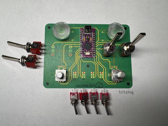 A paper printout of a circuit board with switches and other components laid on top to test spacing and clearances.