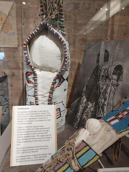 Cradleboards

A cradleboard provides a safe way to care for a baby. Sometimes called "the third mother", the cradleboard could be carried like a backpack, hung from a saddle or doorpost, or propped up near a working parent.

Tribes in different regions have distinctive forms of cradle boards with Plains cradleboards generally having a carved wooden frame covered with heavily beaded hides. The upper part of the cradleboard fitted around the baby's head, protecting it from both sun and rain.

Miniature cradleboard made from hide, cloth and glass beads, Crow, Montana, c. 1915. Gift of John Mitchell.

Cradleboard cover made from leather, cloth, glass beads, Sioux, c. 1910. Gift of the McHenry County Historical Society.

photograph
