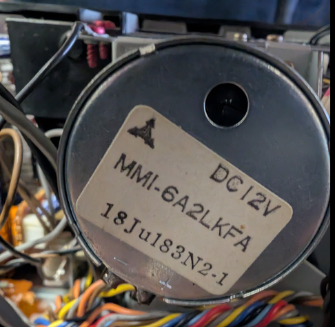 It's a Mitshubishi 12V DC motor with integrated servo electronics.