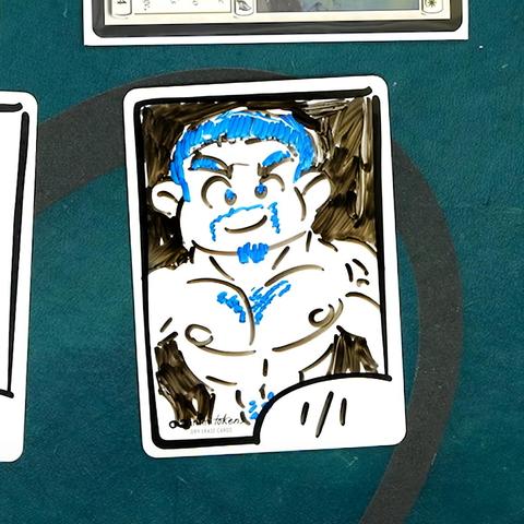 An InfiniTokens dry erase token with a drawing of a buff cartoon character with blue colored hair, beard, chest hair and happy trail. 