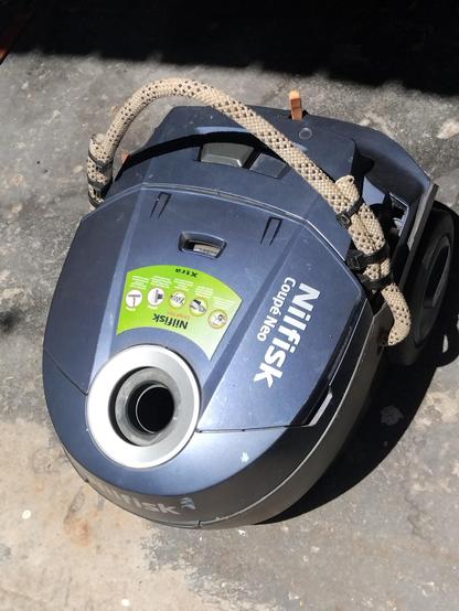 Vacuum cleaner repaired with  a 13mm climbing rope handle.
A small whittled stick is in a socket at the rear of the vacuum cleaner. It is used to push the cord rewind button.