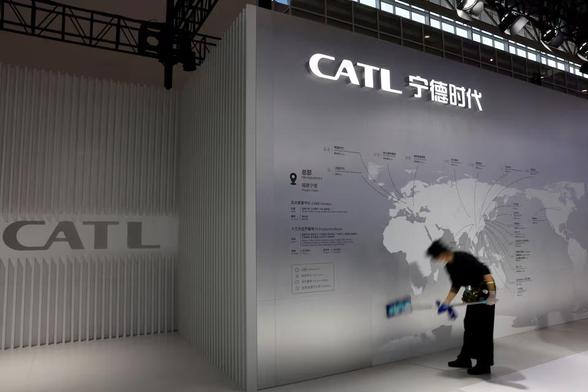 staff member cleans a display showing the locations of battery maker CATL's production bases, at the CATL booth during the first China International Supply Chain Expo (CISCE) in Beijing, China November 28, 2023