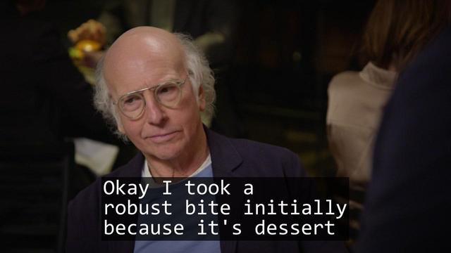A screenshot from the TV show Curb Your Enthusiasm episode S12E07 'The Dream Scheme'.

Over laid is the text of a haiku:

Okay I took a
robust bite initially
because it's dessert