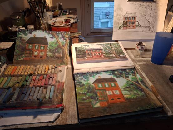Image of an artists studio with bench with reference image, preliminary pencil sketch, first draft and work in progress of a brick home in the Bethlehem historic district