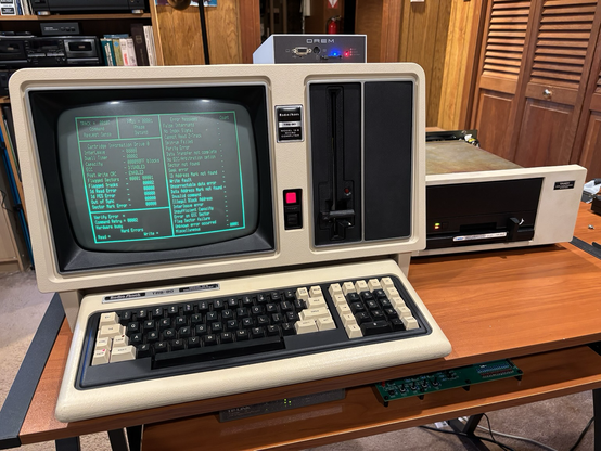 TRS-80 Model 16B computer and disk cartridge system.  The Model 16B is running a diagnostic program.