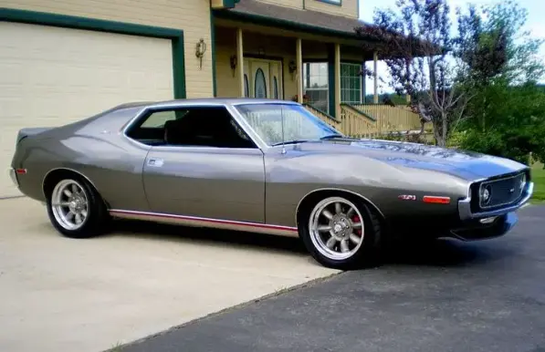 Photo of a restored and tricked out early 1970s AMC or AMX Javelin car. Painted glossy grey with distinctive fenders, 2 door, very nice...