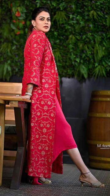 Style meets elegance as Anusree Nair graces the spotlight in a stunning red designer dress. The vibrant hue, combined with its impeccable tailoring, makes this dress a showstopper. A true masterpiece in modern fashion!