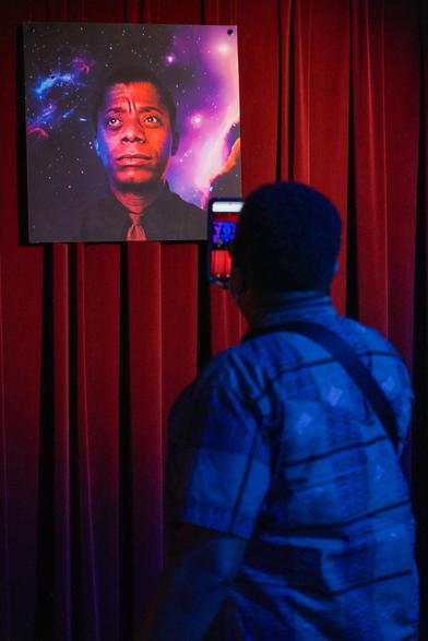 An audience member holding a smartphone and viewing an augmented reality experience I made featuring James Baldwin.