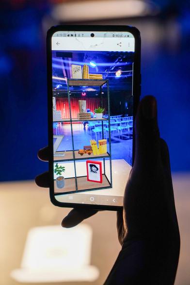 A closeup of an augmented reality experience of a 3D shelf containing books by Zora Neale Hurston.
