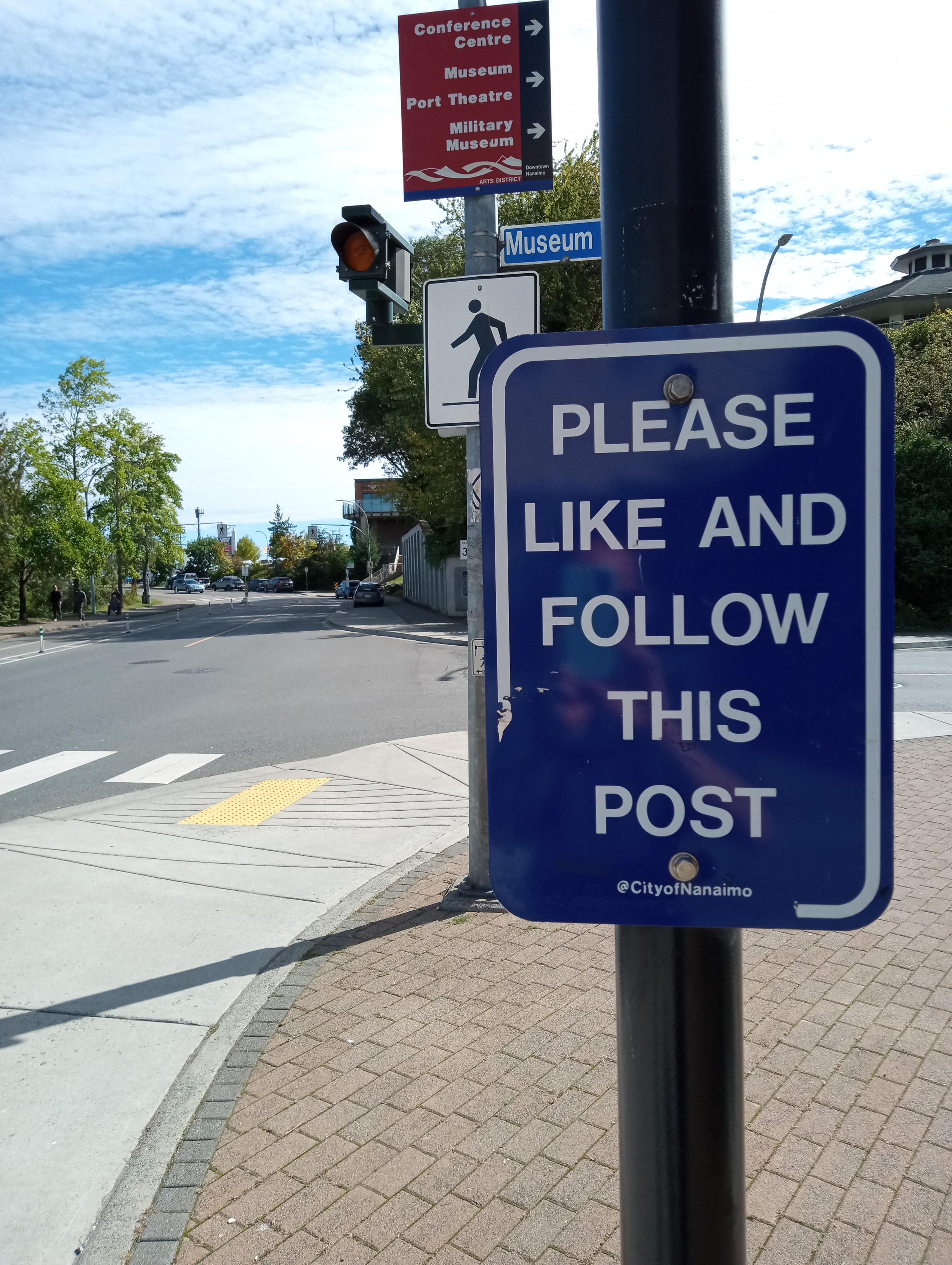 official sign on post reading 'please like and follow this post'