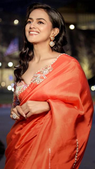 Shraddha Srinath proves that elegance is effortless in her orange saree paired with a designer blouse. A perfect blend of traditional and modern fashion!