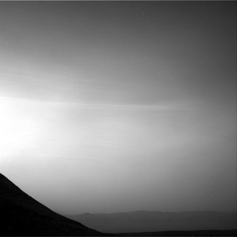 A black and white photography capturing the thinly veiled Martian sky above Gale Crater.