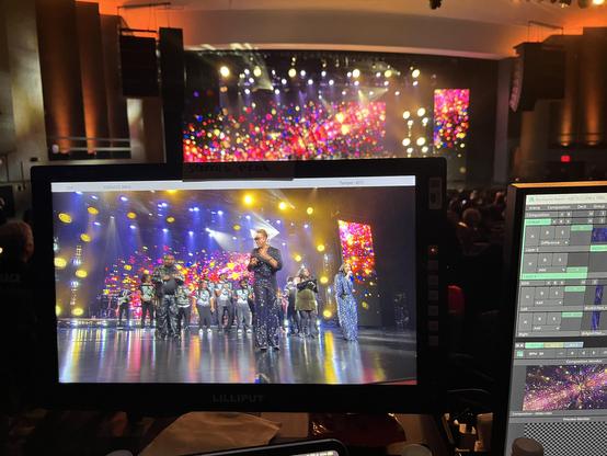 A pic of the monitor from my Screens Producer station with the LED volume on the stage in the background. MC Lyte is performing on stage in front of my screens designs.