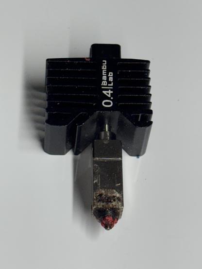 A photo of my beat-up BambuLab 0.4mm nozzle.