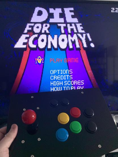 It’s Die for the Economy being played with an arcade controller! Sadly not in an arcade cabinet yet though..