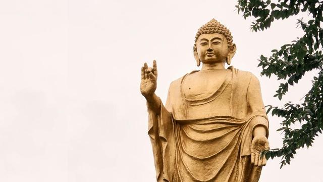 Giant standing gold Buddha statue.