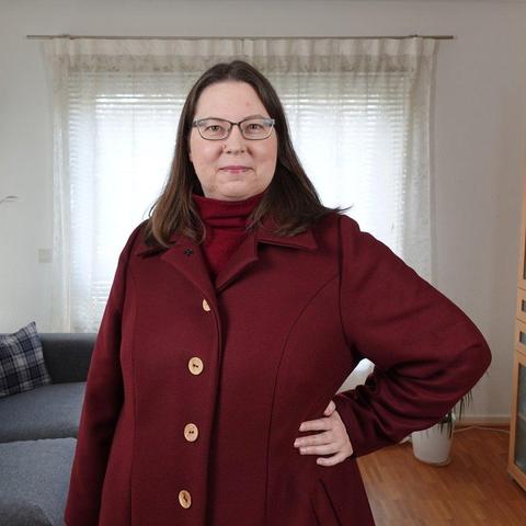 Woman in a red wool coat facing the camera